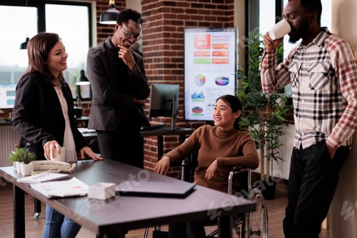 Preview: Company manager wheelchair user with disability laughing with people
