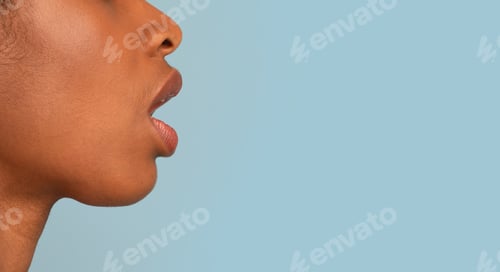 Preview: Profile Shot Of Black Woman Standing With Opened Mouth Over Blue Background