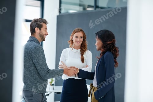 Preview: Unified as a team is how they work best. Cropped shot of businesspeople shaking hands in an office.