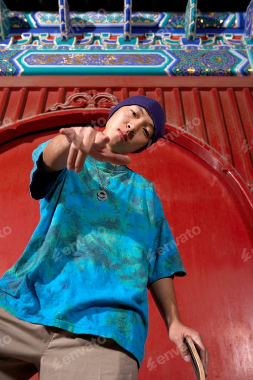 Preview: Teenage Boy With Skateboard Doing Devil Horns