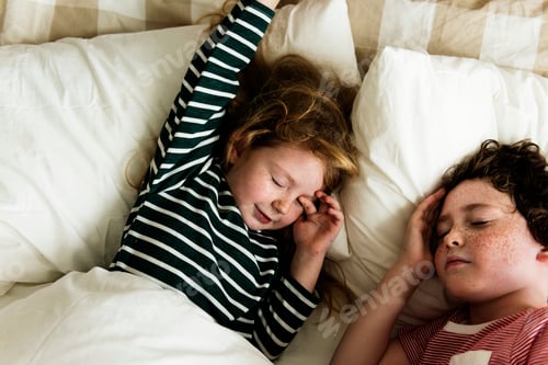 Preview: A Caucasian siblings sleeping on the bed