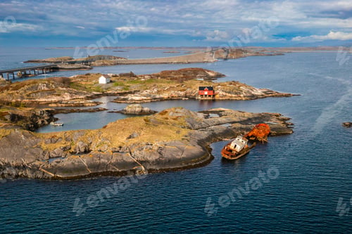 Preview: Abandoned Rusty Shipwreck Near Red Boathouse, Scenic Atlantic Ocean Road Landscape, Norway