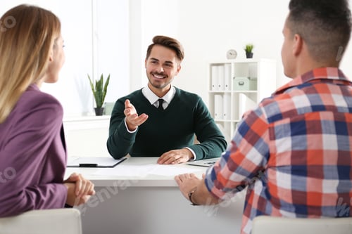 Preview: Real estate agent consulting young couple in office