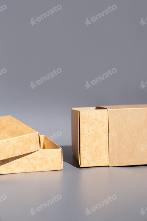 Preview: Brown cardboard gift boxes on gray background with open lid and sliding drawer