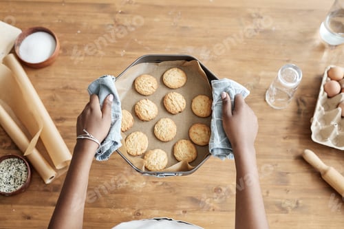 Preview: Little girl holding tray with homemade cookies top view