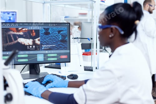 Preview: Back view of african researcher working on computer