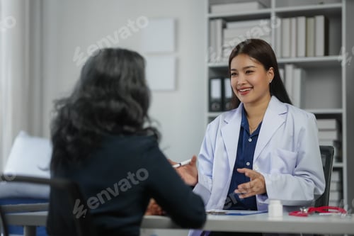 Preview: A female doctor in a white coat consulting with a patient in a modern medical office setting.