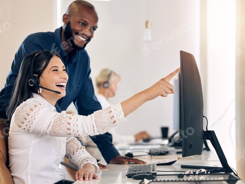 Preview: Shot of two call centre agents working together on a computer in an office