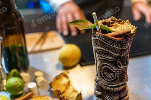 Preview: Closeup of a tropical cocktail at party in a nightclub. Nightlife concept with copy-space for text.