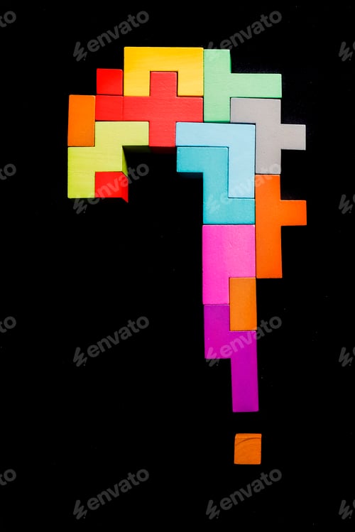 Preview: question mark wooden blocks on black background. Geometric shapes in different colors.