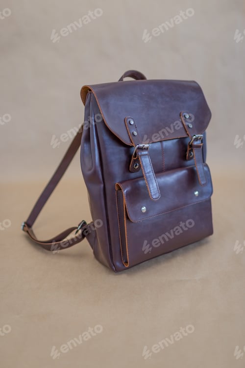Preview: Brown leather backpacks isolated on beige background