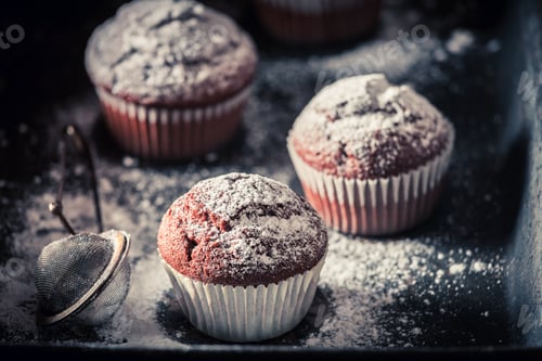 Preview: Homemade chocolate muffin with powdered sugar. Chocolate cupcake with nuts.