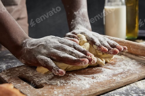 Preview: Man`s hands kneads dough on wooden counter, going to roll it and make cakes, works at kitchen, isola