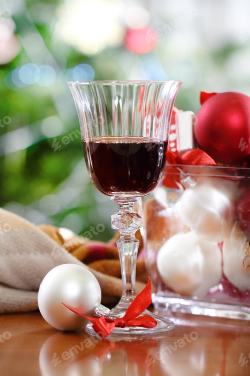Preview: Glass of red wine and Christmas decorations