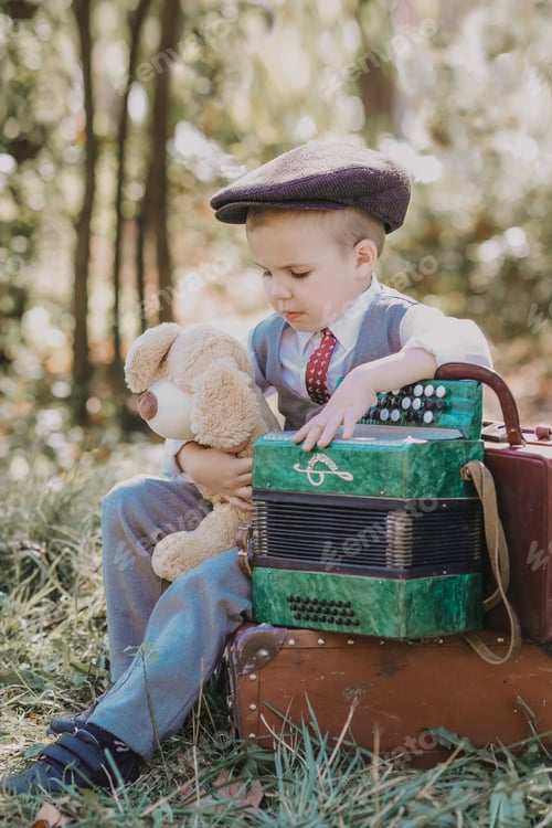 Preview: A little boy in a cap with an accordion