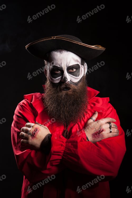 Preview: Scary bearded pirate with hands crossed over black background