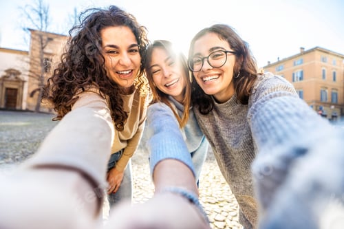 Preview: Three young women taking selfie pic with cellphone outside