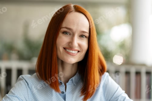 Preview: Portrait of beautiful smiling red haired student standing in university campus, education concept