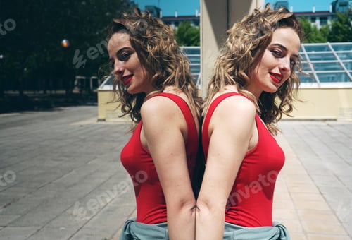 Preview: Pretty young woman against a mirror wall