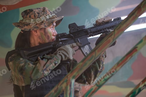 Preview: Asian beautiful woman soldier hold the gun and point to target on over direction