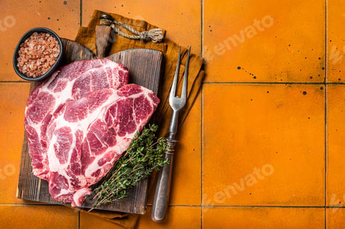 Preview: Raw pork steak chops, neck meat with herbs. Orange background. Top view. Copy space
