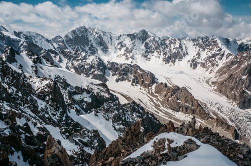 Preview: view of mountains rocky peaks in snow under clouds, Ala Archa National Park, Kyrgyzstan