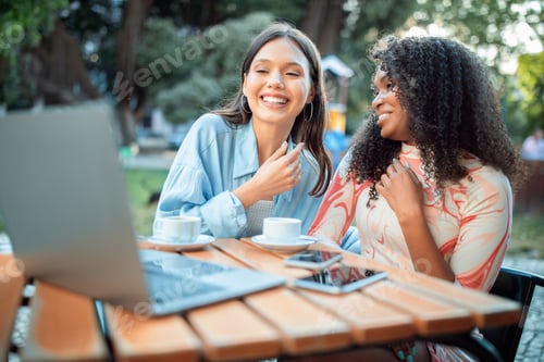 Preview: Two friends enjoying coffee and conversation outdoors in a sunny cafe setting