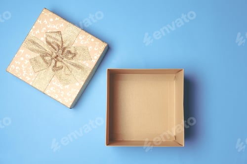 Preview: Top view of open gift box on blue background.