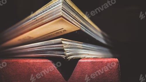 Preview: Closeup of a stack of books in a dark room