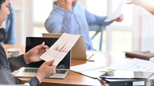 Preview: Business Colleagues Discussing Graphs in an Office
