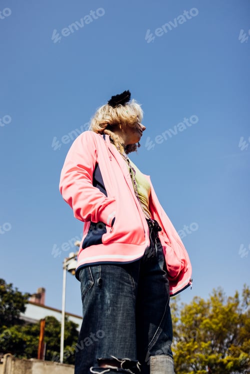 Preview: Young nonconformist rebel woman gender fluid posing outdoor looking over pensive