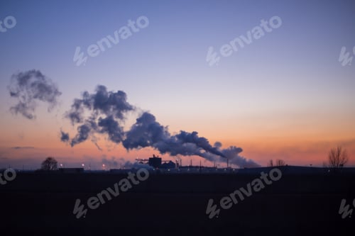 Preview: Cloud of smoke over industrial park at sunset