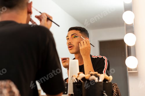 Preview: young drag queen wearing make-up in front of the stage