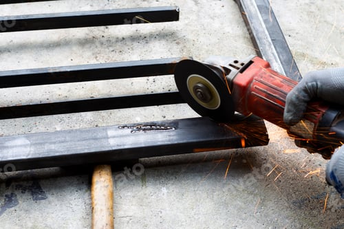 Preview: Close up, A man working with angle grinder. Iron gate repair