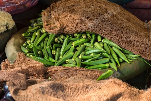 Preview: Pile of fresh okra for sale in market