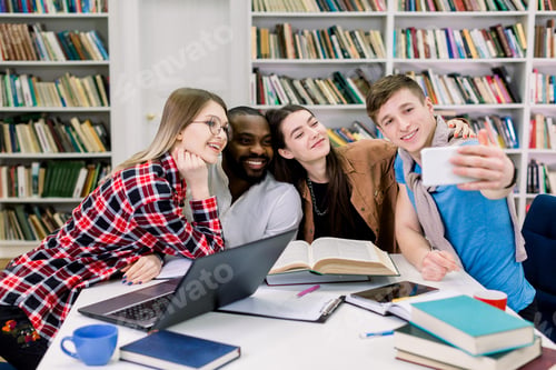 Preview: Multiethnical smiling happy students are studying in library, having fun during break and making