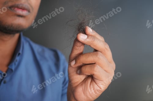 Preview: man hold his list hair close up