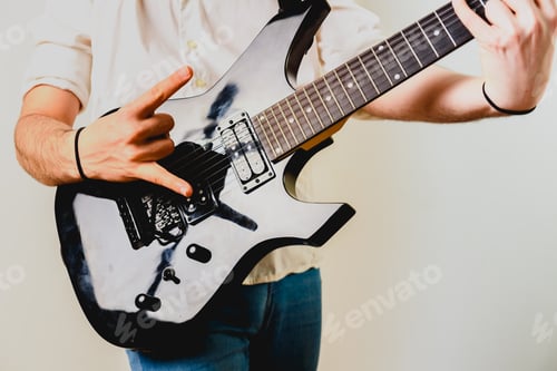Preview: Guitarist playing his electric guitar, isolated background.