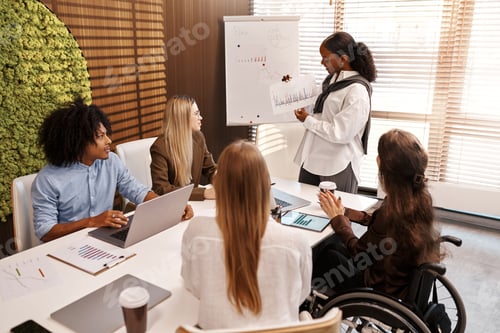 Preview: Businesswoman presenting graph to diverse team during office meeting