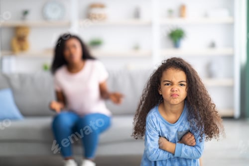 Preview: Little black girl feeling angry, taking offence at her mother at home, copy space. Parent child