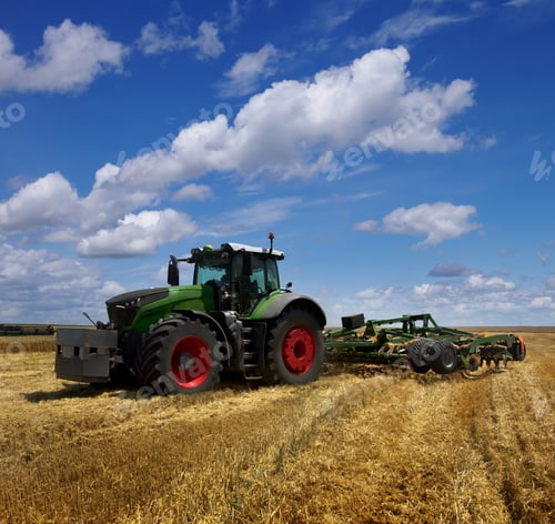 Preview: Modern agricultural tractor working in the field after harvesting