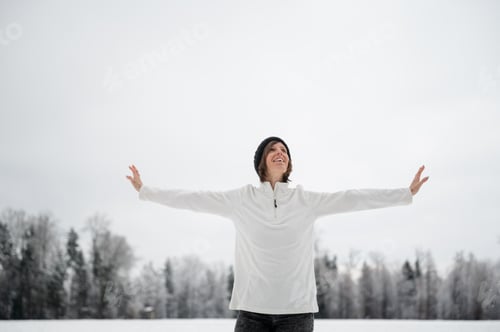 Preview: Woman Enjoying the Winter Snow with Open Arms