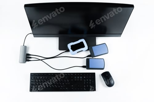 Preview: Multiple external hard drives connected to a monoblock on a white background.Computer with hard