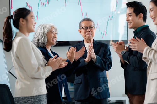Preview: Colleagues applauding financial achievement, sharing excitement in corporate workspace