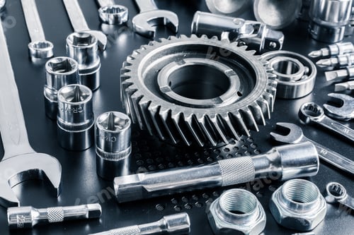 Preview: Collection of various metal tools and gears arranged on a workbench for mechanical repairs and