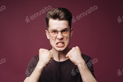 Preview: Determined furious man holding fists up