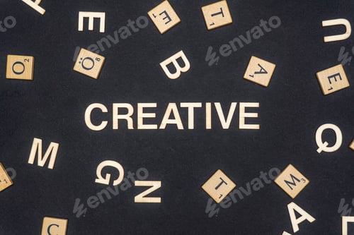 Preview: CREATIVE word written on dark paper background. CREATIVE text for your concepts