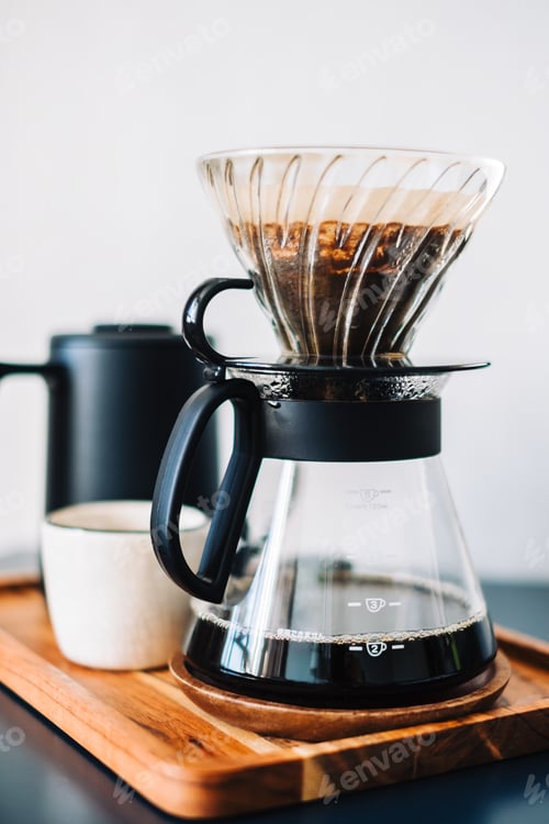 Preview: Fresh brewed coffee in a cup using Alternative method, with pour over dripper and paper filter.