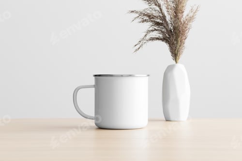 Preview: Enamel mug mockup with a dry flower decoration on the wooden table.