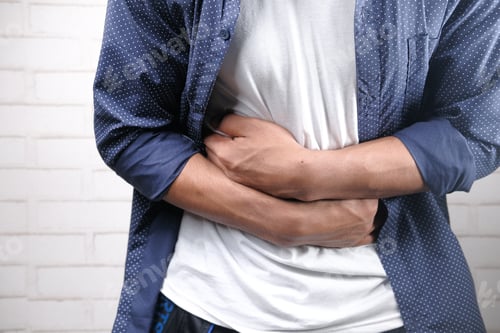 Preview: young man suffering stomach pain close up.